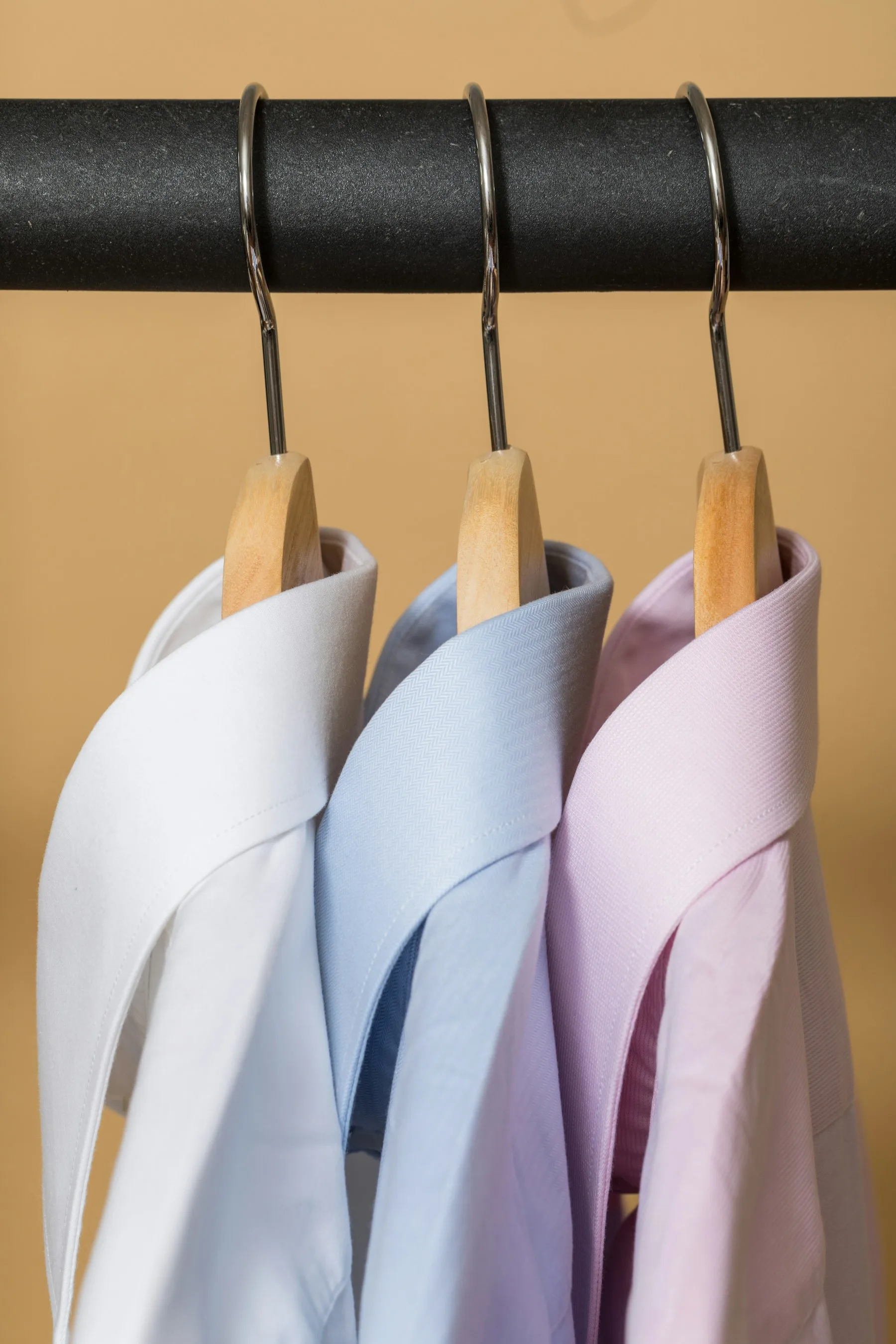 Tailor working with measuring tape and jacket fabric