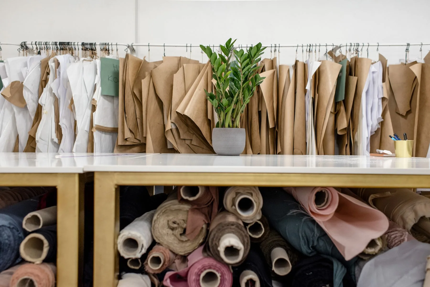Fabric rolls and sewing patterns inside a tailoring atelier